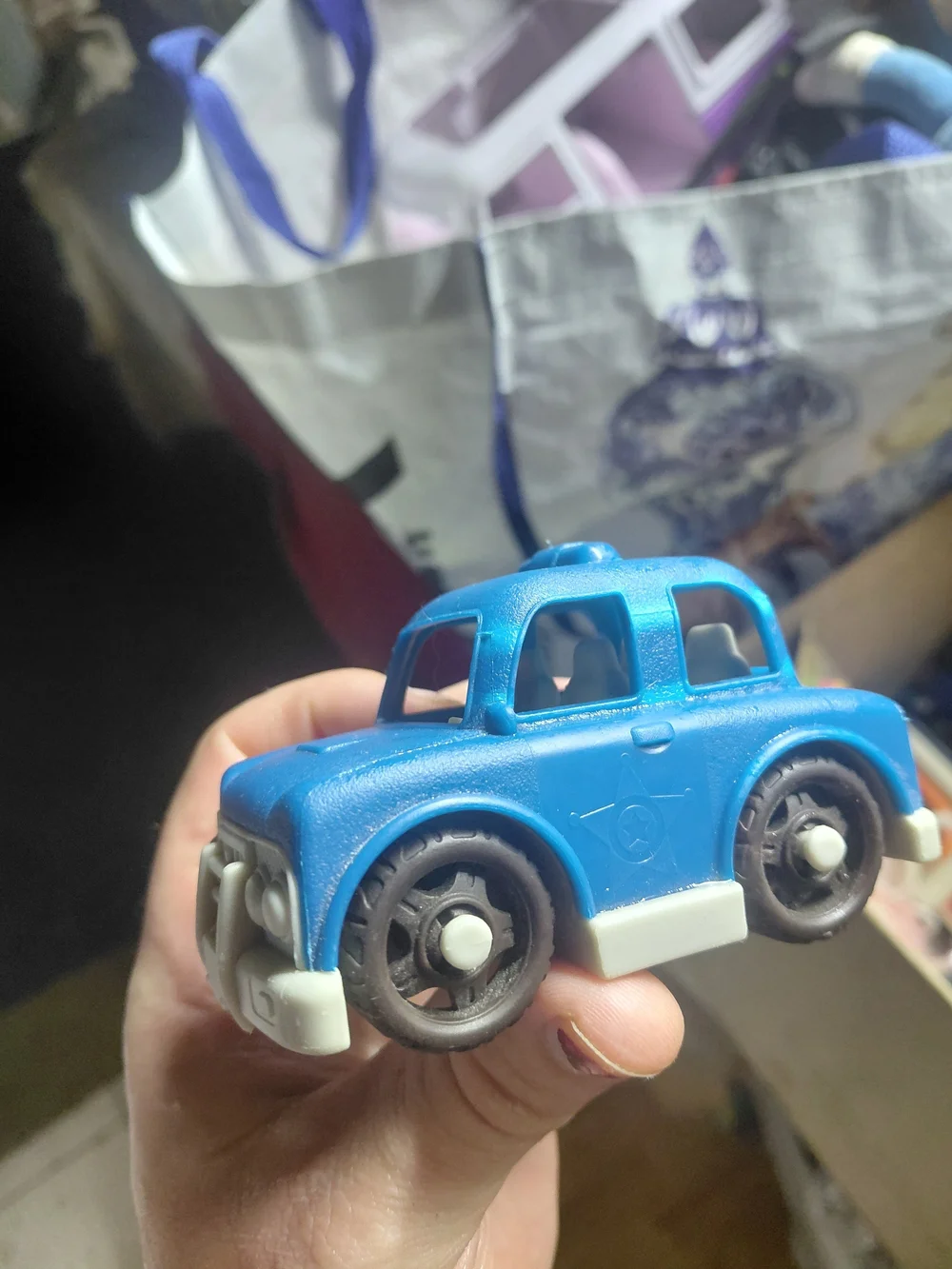 blue and white B. toys Happy Cruisers mini car toy toddlers.  Police car